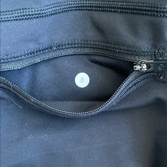 Black, cropped Lululemon leggings with pockets, ruched bottoms and zipped pocket - Picture 9 of 15